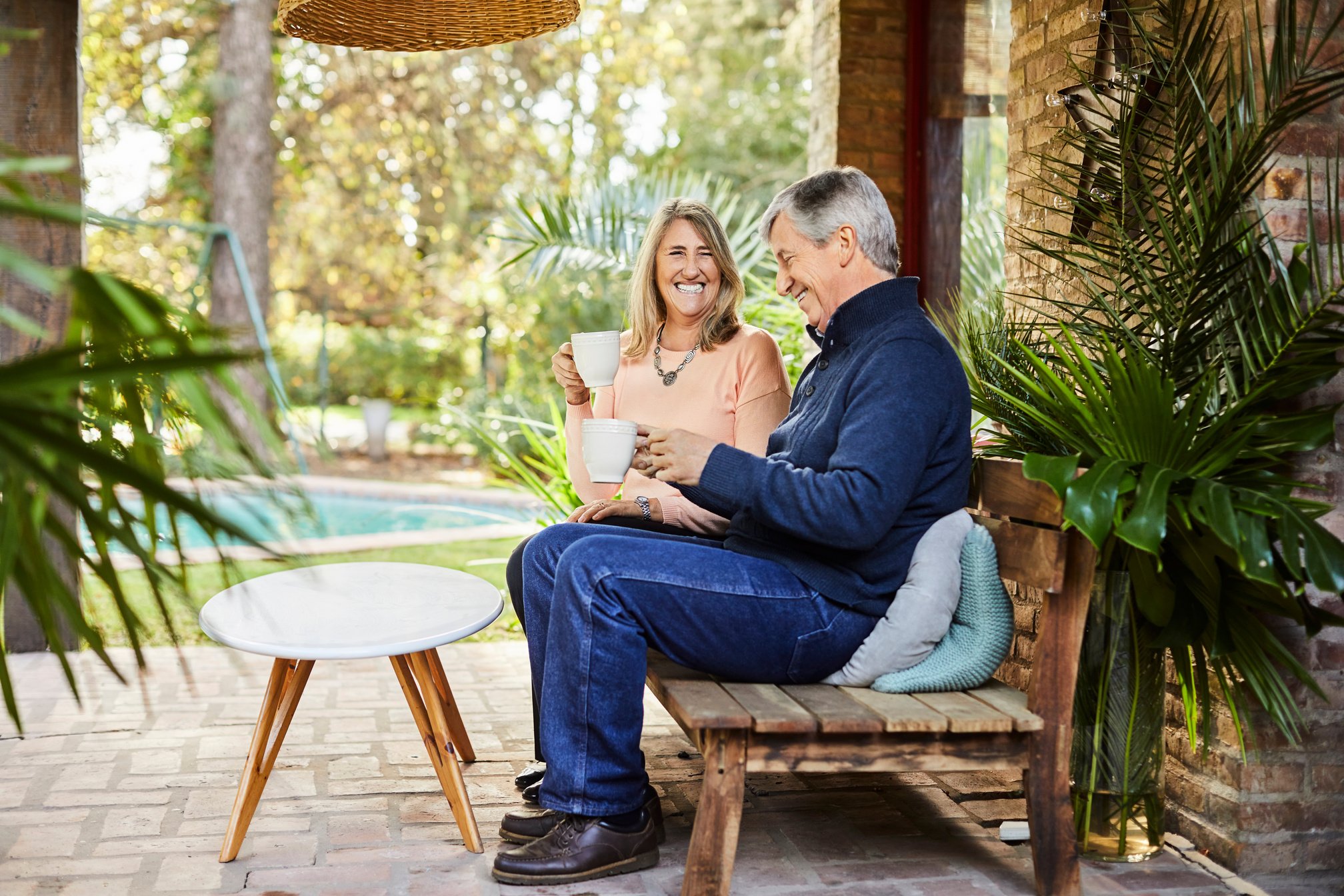 Elderly couple enjoying coffee at patio